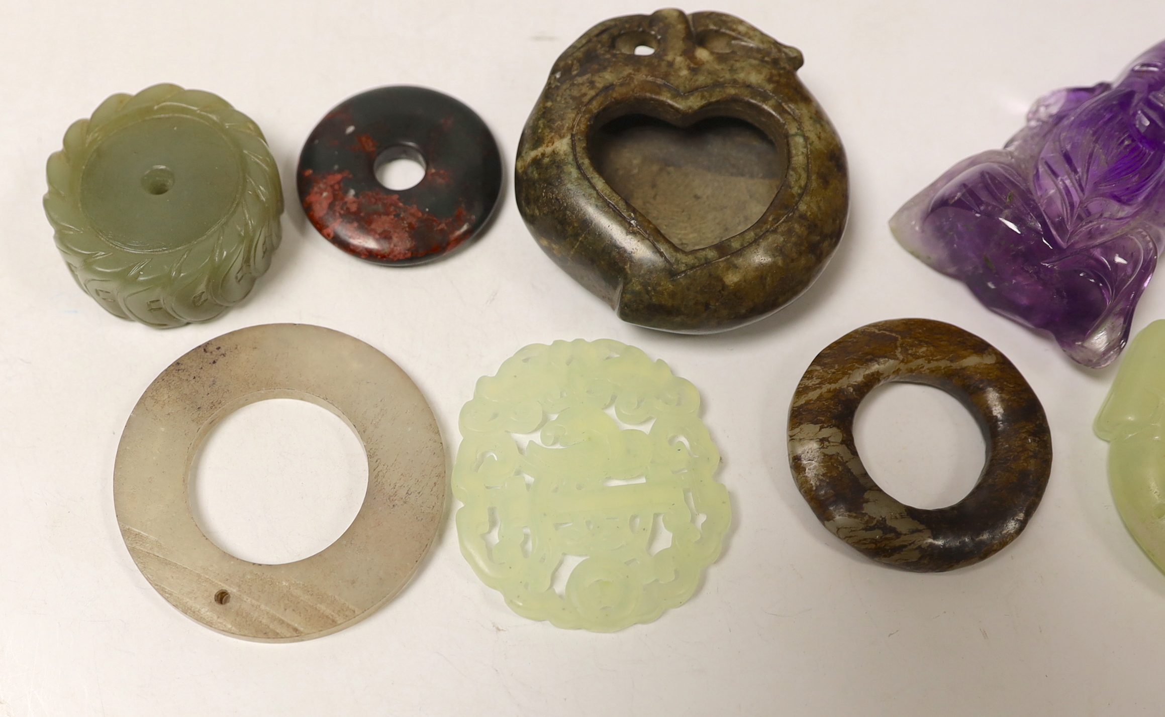 Eight Chinese jade or hardstone carvings including discs, largest 6cm in diameter